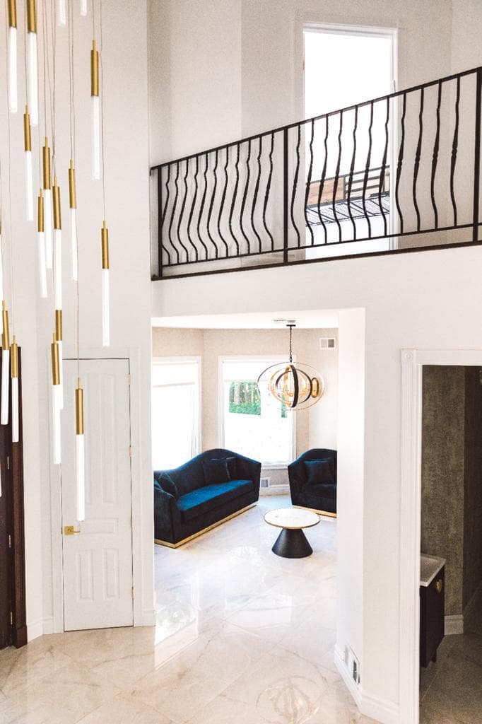 Double-height foyer and formal living beyond the arch