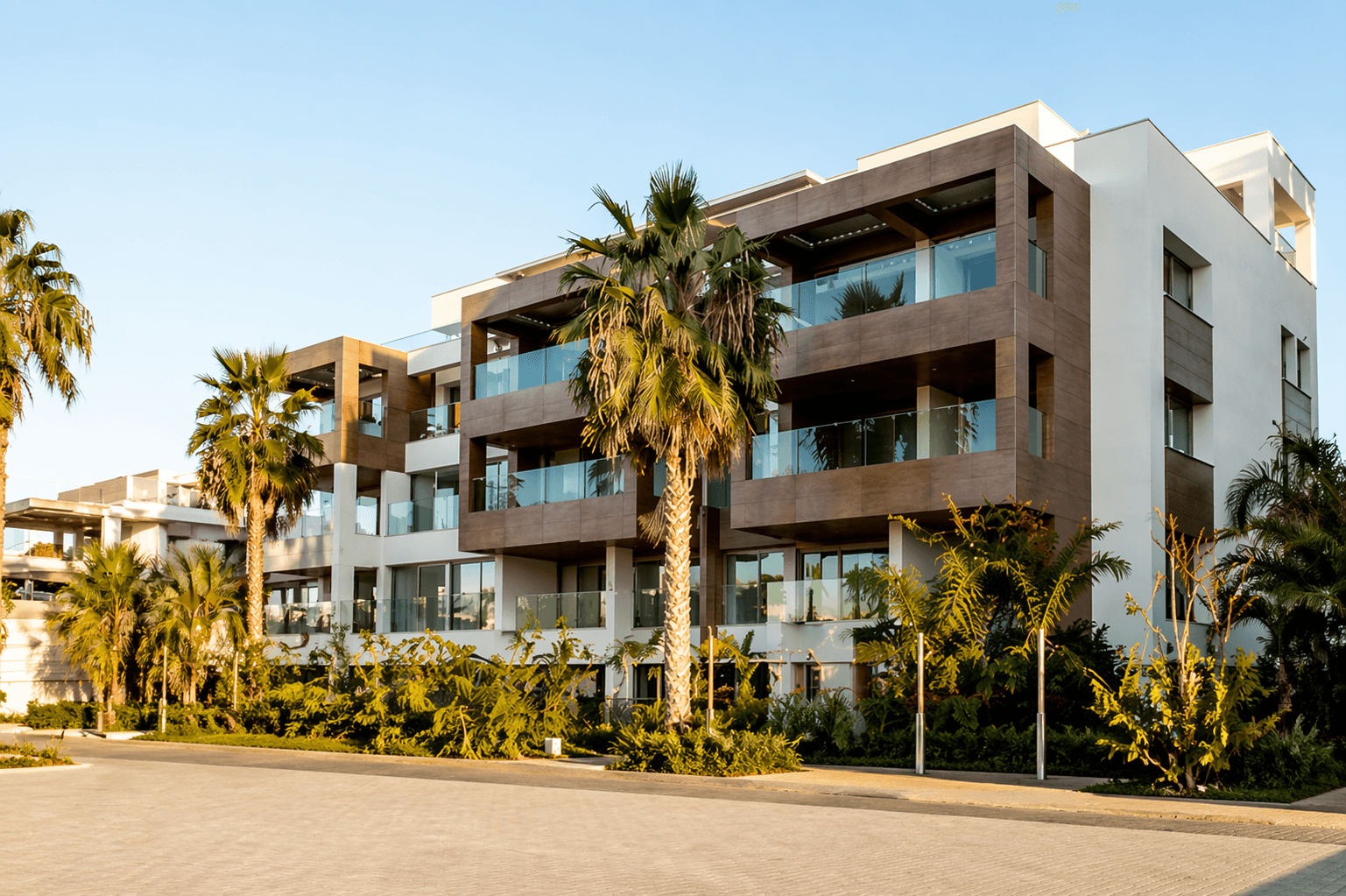 Kosher boutique hotel, ocean front apartments in Miami, FL: modern building with balconies and palm trees