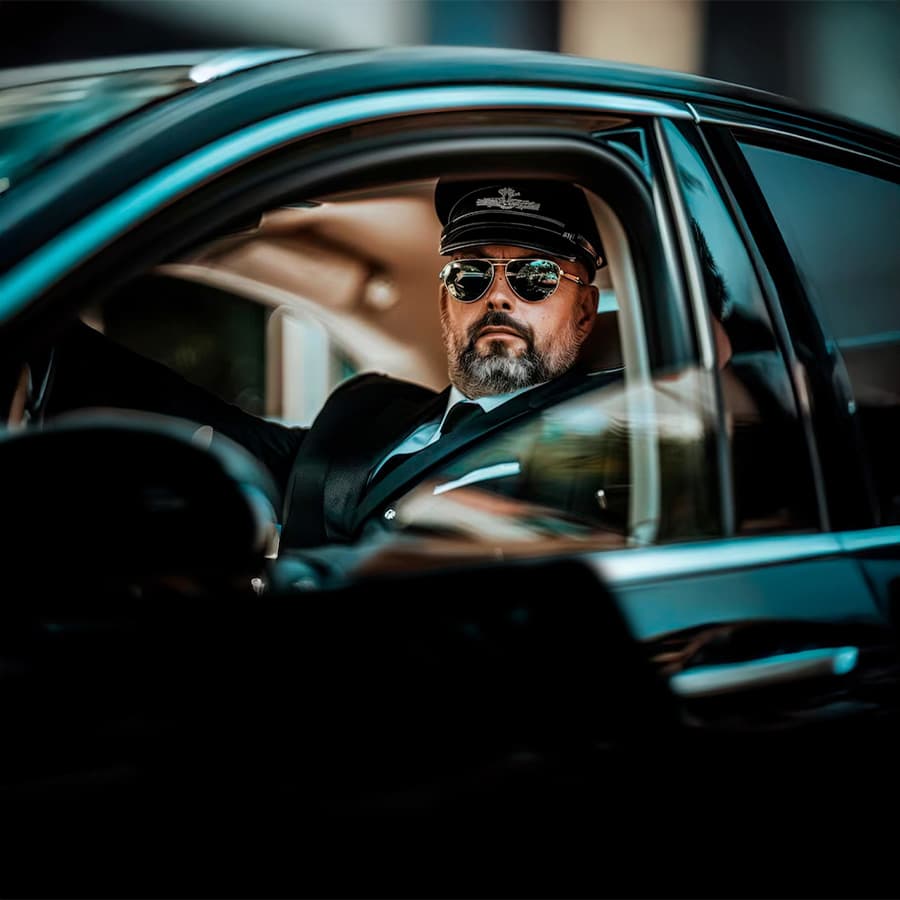 Professional chauffeur with luxury vehicle